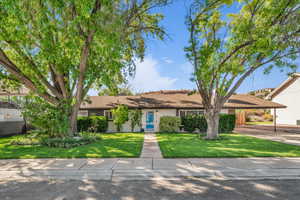 View of front of house featuring a front yard and a carport