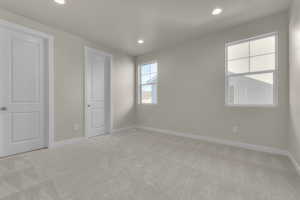 Unfurnished room with light carpet