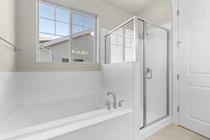 Bathroom with tile patterned flooring and plus walk in shower