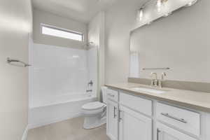 Full bathroom with tile patterned flooring, vanity, bathing tub / shower combination, and toilet