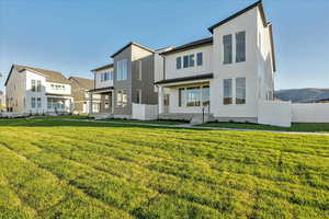 Back of house featuring a lawn