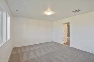 Spare room featuring light colored carpet