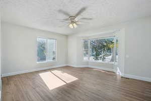 Spare room featuring light hardwood / wood-style floors, a textured ceiling, and ceiling fan