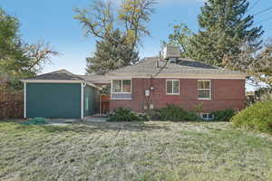 Rear view of house featuring a yard