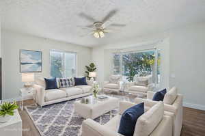 Living room featuring a textured ceiling, hardwood / wood-style flooring, and ceiling fan