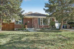 View of front of house featuring a front lawn and a garage