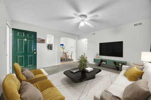 Spacious living room with carpet and ceiling fan