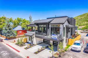 View of front of house featuring a garage and a balcony