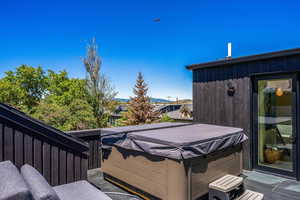 Wooden deck featuring a hot tub