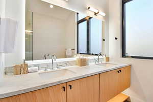 Bathroom with vanity, an enclosed shower, and lofted ceiling