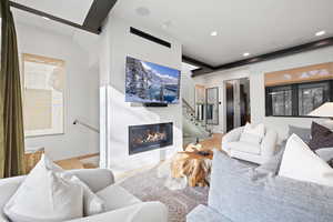 Living room with light hardwood / wood-style floors and vaulted ceiling