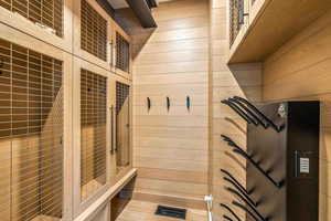 Mudroom featuring wood walls