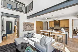 Living room featuring sink and light hardwood / wood-style flooring