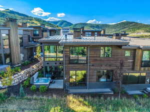 Back of property with a patio, a mountain view, and outdoor lounge area