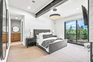 Carpeted bedroom with beamed ceiling