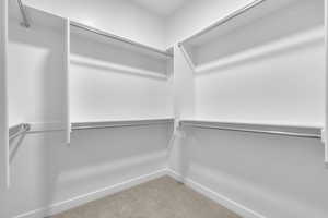 Walk in closet featuring carpet floors