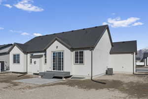 Back of house with a patio area and central AC