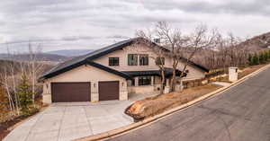 View of front of property featuring a mountain view and a garage