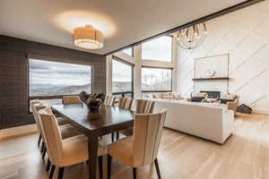 Dining room featuring an inviting chandelier, a mountain view, and light hardwood / wood-style floors