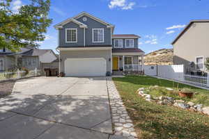 Front facade with a front yard and a garage