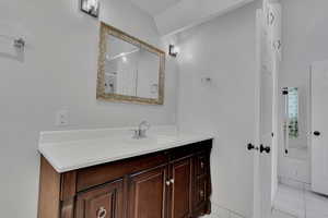 Bathroom featuring vanity and tile patterned floors