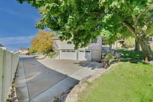 View of front of house featuring a front lawn and a garage