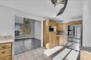 Kitchen with light hardwood / wood-style floors, tasteful backsplash, and appliances with stainless steel finishes