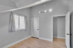 Unfurnished bedroom featuring light wood-type flooring