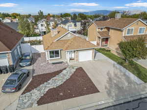 View of front of house featuring central AC, a garage, and a mountain view