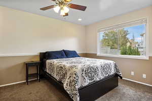 Carpeted bedroom with ceiling fan