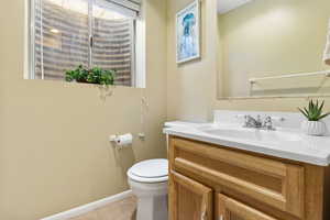 Bathroom with vanity, toilet, and tile patterned flooring