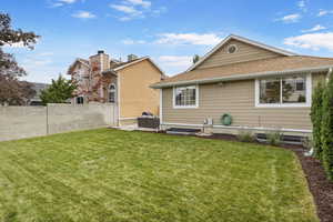 Rear view of property featuring a patio and a lawn