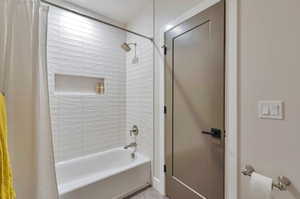 Bathroom with shower / bath combination with curtain