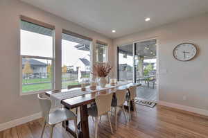 Dining room featuring light hardwood / wood-style flooring and a healthy amount of sunlight