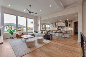 Living room with light hardwood / wood-style flooring, sink, and ceiling fan