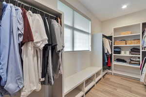 Walk in closet featuring light hardwood / wood-style flooring