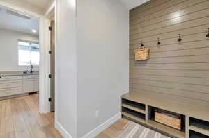 Mudroom with light hardwood / wood-style floors