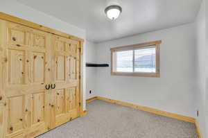 Carpeted bedroom featuring a textured ceiling