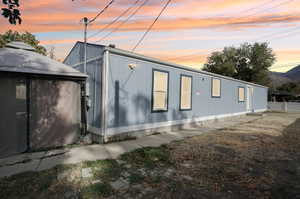 Property exterior at dusk featuring a mountain view