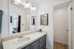 Bathroom featuring vanity and hardwood / wood-style floors