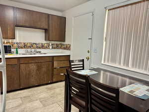 Kitchen with sink and dark brown cabinets