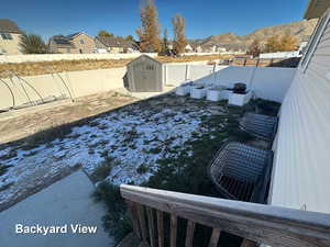 View of yard featuring a mountain view and a storage unit