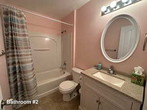 Full bathroom featuring tile patterned flooring, vanity, shower / bath combo, and toilet