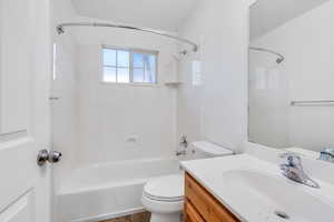 Full bathroom featuring vanity, toilet, and shower / tub combination