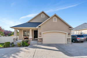 View of front of house with a porch and a garage