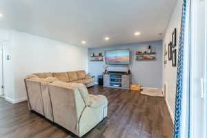 Living room with dark hardwood / wood-style floors