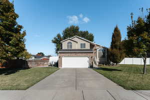 Front facade featuring a front yard and a garage