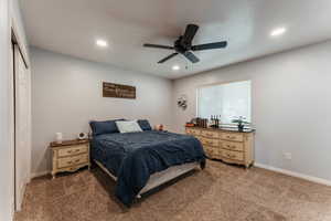 Bedroom with carpet floors, a closet, and ceiling fan