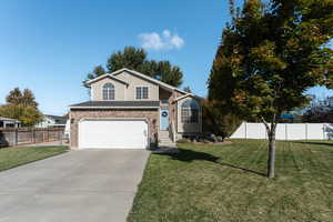 Front of property with a front lawn and a garage