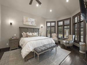 Bedroom with ceiling fan, vaulted ceiling, and dark hardwood / wood-style floors